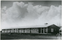 Schools delivered to the Netherlands featured an elongated single-story volume covered by a gently sloping roof and large windows to the south.